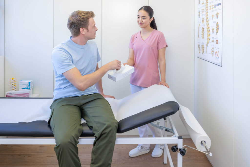 Arzthelferin bietet Patient tuch